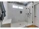 Modern all-tile shower features glass door, bench, dual shower heads, and accent tiling at 2780 Gallant Hills Dr, Las Vegas, NV 89135