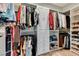 Spacious walk-in closet with custom shelving, multiple hanging rods, and laminate wood flooring at 2780 Gallant Hills Dr, Las Vegas, NV 89135
