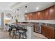 Stylish wet bar with granite countertop, wine cooler, and seating for entertaining at 30 Via Mantova # 109, Henderson, NV 89011