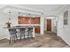 Stylish wet bar with granite countertop, wine cooler, and seating for entertaining at 30 Via Mantova # 109, Henderson, NV 89011