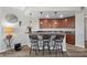 Stylish wet bar with granite countertop, wine cooler, and seating for entertaining at 30 Via Mantova # 109, Henderson, NV 89011