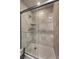 Luxurious walk-in shower with marble tiling, bench, and mounted shower head at 30 Via Mantova # 109, Henderson, NV 89011