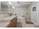 Elegant bathroom with dual sinks, soaking tub, and glass-enclosed shower at 30 Via Mantova # 109, Henderson, NV 89011