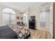 Bright bedroom featuring a large window and a mirrored closet at 30 Via Mantova # 109, Henderson, NV 89011