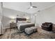 Cozy bedroom with plush rug, chair and ottomans, and en suite bathroom access at 30 Via Mantova # 109, Henderson, NV 89011