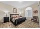 Cozy bedroom featuring floral bedding, decorative pillows, and a tufted headboard at 30 Via Mantova # 109, Henderson, NV 89011