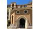 Stunning multi-story building with unique arched entry, round windows, and decorative lighting at 30 Via Mantova # 109, Henderson, NV 89011