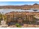 Stunning exterior view of multi-story building with red tile roof, manicured landscaping, and lake view at 30 Via Mantova # 109, Henderson, NV 89011