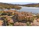 Beautiful multi-unit homes highlighting red tile roofs, mature palm trees, waterfront views, and inviting pool at 30 Via Mantova # 109, Henderson, NV 89011