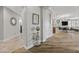 Inviting hallway with decorative accents, leading to open-concept living areas and beautiful hardwood floors at 30 Via Mantova # 109, Henderson, NV 89011