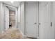 Hallway access to luxurious walk-in shower featuring marble tiling, bench, and mounted shower head at 30 Via Mantova # 109, Henderson, NV 89011