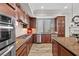 This kitchen has stainless steel appliances, wood cabinets, stone countertops, tile backsplash, and a large island at 30 Via Mantova # 109, Henderson, NV 89011