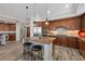 This kitchen has wooden cabinets, stainless steel appliances, granite countertops, and a large island with bar seating at 30 Via Mantova # 109, Henderson, NV 89011