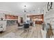 Open-concept kitchen and dining area with wood cabinets and a modern chandelier at 30 Via Mantova # 109, Henderson, NV 89011