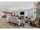 This living room has a stone fireplace, hardwood floors, a kitchen view, and modern furniture for relaxation and entertainment at 30 Via Mantova # 109, Henderson, NV 89011