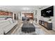 Open-concept living room with modern decor, fireplace, and adjoining kitchen at 30 Via Mantova # 109, Henderson, NV 89011