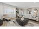 Bright living room boasts neutral colors, wood floors, and sliding glass door access to outdoor living at 30 Via Mantova # 109, Henderson, NV 89011