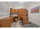 This office features a stylish wooden desk and a pull-down Murphy bed for versatile use of the space at 30 Via Mantova # 109, Henderson, NV 89011