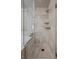 Walk-in shower featuring light stone tiling and built in shelves at 30 Via Mantova # 109, Henderson, NV 89011