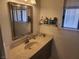 Bright bathroom features a large mirror over the vanity and a shelf next to the window at 3164 Elmrock Pl, Las Vegas, NV 89121