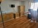 Bedroom with hardwood floors, natural light, television, and coordinated bedside tables and armoire at 3164 Elmrock Pl, Las Vegas, NV 89121