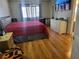 Comfortable bedroom features a cozy red blanket on the bed with wood floors at 3164 Elmrock Pl, Las Vegas, NV 89121