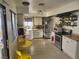 Well-lit kitchen featuring white cabinetry, stainless steel appliances, and a breakfast nook at 3164 Elmrock Pl, Las Vegas, NV 89121