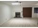Living room features light flooring, fireplace with dark tile, and natural light from a window and skylight at 3164 Elmrock Pl, Las Vegas, NV 89121