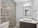 Stylish powder room featuring a vessel sink, modern fixtures, and textured tile accent wall at 3165 S Monte Cristo Way, Las Vegas, NV 89117