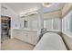 Modern bathroom featuring a tub, walk in closet, stone floors and a large vanity at 3165 S Monte Cristo Way, Las Vegas, NV 89117