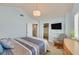 Well-lit bedroom with a TV, rocking chair, walk-in closet, and plush carpet at 3165 S Monte Cristo Way, Las Vegas, NV 89117