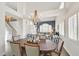 Open-concept dining room with modern chandelier, open floor plan, and hardwood table with chairs at 3165 S Monte Cristo Way, Las Vegas, NV 89117