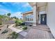 Inviting front entrance featuring a brick pathway and mature, landscaped greenery and trees at 3165 S Monte Cristo Way, Las Vegas, NV 89117