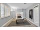 Home gym featuring a fireplace, exercise bench, a mounted TV and window with shutters at 3165 S Monte Cristo Way, Las Vegas, NV 89117