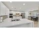 Modern kitchen with white cabinets, quartz countertops, stainless steel appliances, and decorative backsplash at 3165 S Monte Cristo Way, Las Vegas, NV 89117