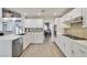 Bright kitchen with white cabinets, quartz countertops, stainless steel appliances, and decorative backsplash at 3165 S Monte Cristo Way, Las Vegas, NV 89117