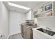 Well-organized laundry room with new washer and dryer and utility sink at 3165 S Monte Cristo Way, Las Vegas, NV 89117