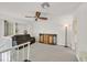 Upstairs loft area with a cozy couch, neutral carpet, and a fan to help cool the space at 3165 S Monte Cristo Way, Las Vegas, NV 89117