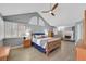 Spacious main bedroom featuring a ceiling fan, fireplace, wood floors, and multiple windows at 3165 S Monte Cristo Way, Las Vegas, NV 89117