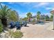 Relax in style on the spacious patio featuring comfortable lounge furniture, lush landscaping, and serene views at 3165 S Monte Cristo Way, Las Vegas, NV 89117