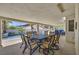Covered patio with outdoor dining and seating area, with view of the pool and palm trees at 3165 S Monte Cristo Way, Las Vegas, NV 89117