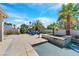 Beautiful backyard oasis featuring a sparkling pool, spa and desert landscaping and patio seating at 3165 S Monte Cristo Way, Las Vegas, NV 89117