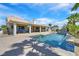 Beautiful backyard with a sparkling pool, covered patio, and lush landscaping, perfect for entertaining at 3165 S Monte Cristo Way, Las Vegas, NV 89117