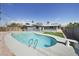 Backyard with a private in-ground swimming pool, gray concrete surround, and some green space at 3905 Casa Grande Ave, Las Vegas, NV 89102