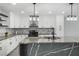 Modern kitchen with stylish waterfall island, stainless steel appliances, and ample cabinet space at 3905 Casa Grande Ave, Las Vegas, NV 89102