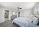 Bright main bedroom featuring wood-look floors, a ceiling fan, and ensuite bathroom at 3905 Casa Grande Ave, Las Vegas, NV 89102