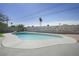 Large in-ground pool surrounded by concrete patio, with views of the fenced backyard at 3905 Casa Grande Ave, Las Vegas, NV 89102