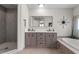 Modern bathroom featuring a double vanity, soaking tub, walk-in shower, and updated fixtures at 4185 W Arby Ave, Las Vegas, NV 89118