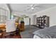 Spacious bedroom with hardwood floors, a ceiling fan, and a sliding mirror closet at 4185 W Arby Ave, Las Vegas, NV 89118