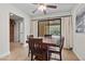 Dining area features a wooden table and chairs next to a sliding glass door leading to a backyard at 4185 W Arby Ave, Las Vegas, NV 89118